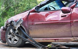 Red car in crash with severe damage