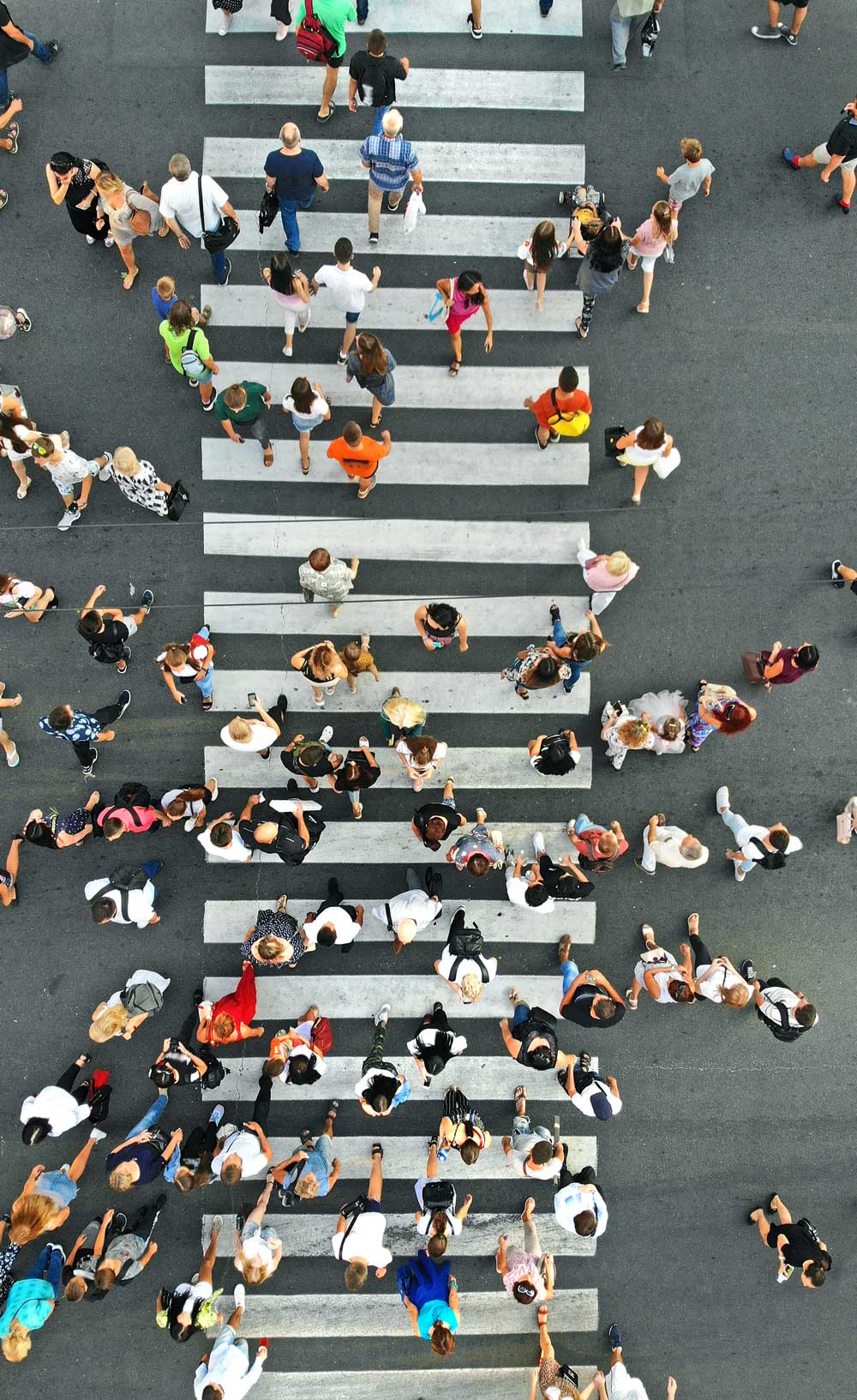 Aerial view of a bunch of people crossing a big street