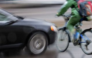 Bicycle rider about to be hit by a car