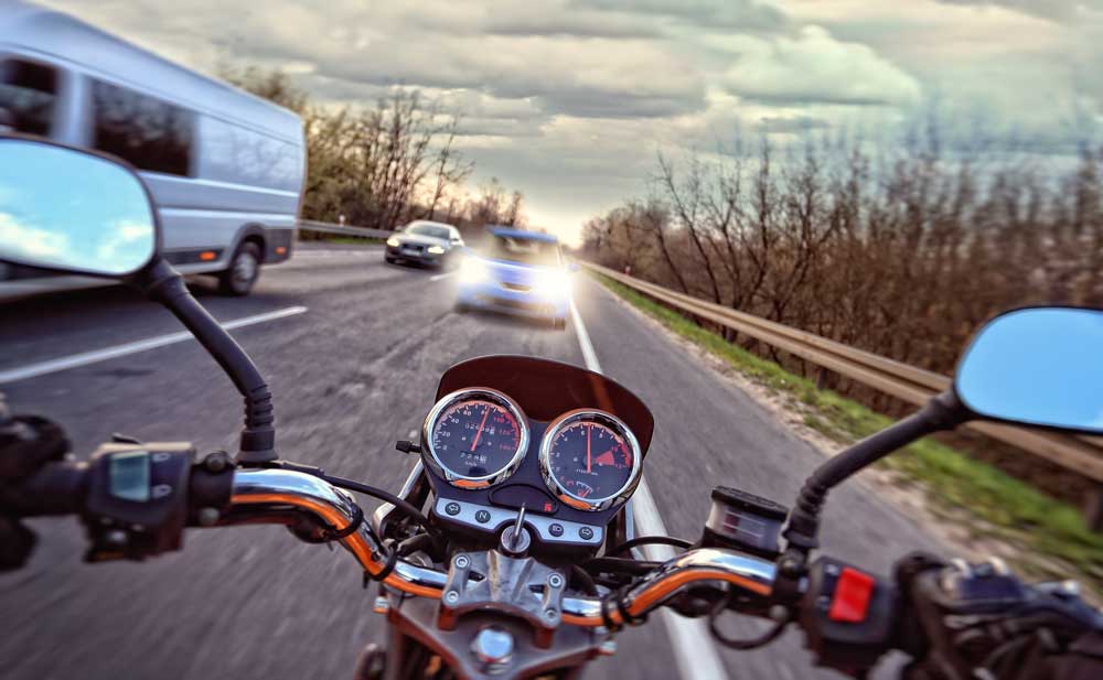 From a first person perspective this photo shows a motorcyclist driving head first into oncoming traffic potentially causing an accident and requiring a motorcycle accident lawyer. 