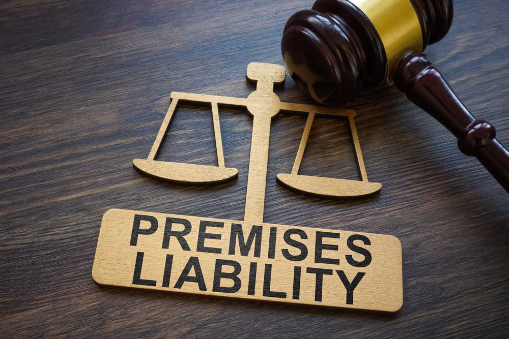 Premises liability wood cut out on a table with a gavel