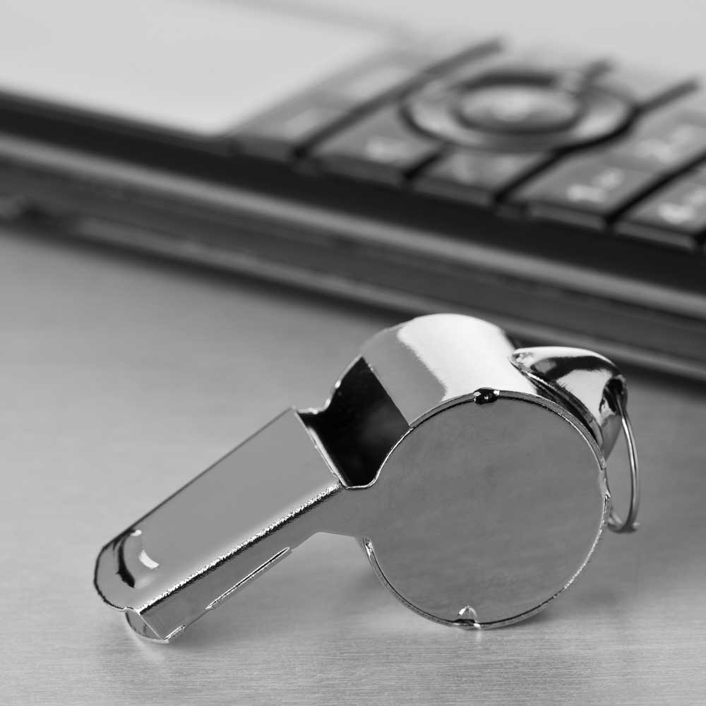 Whistle and a cell phone on a table