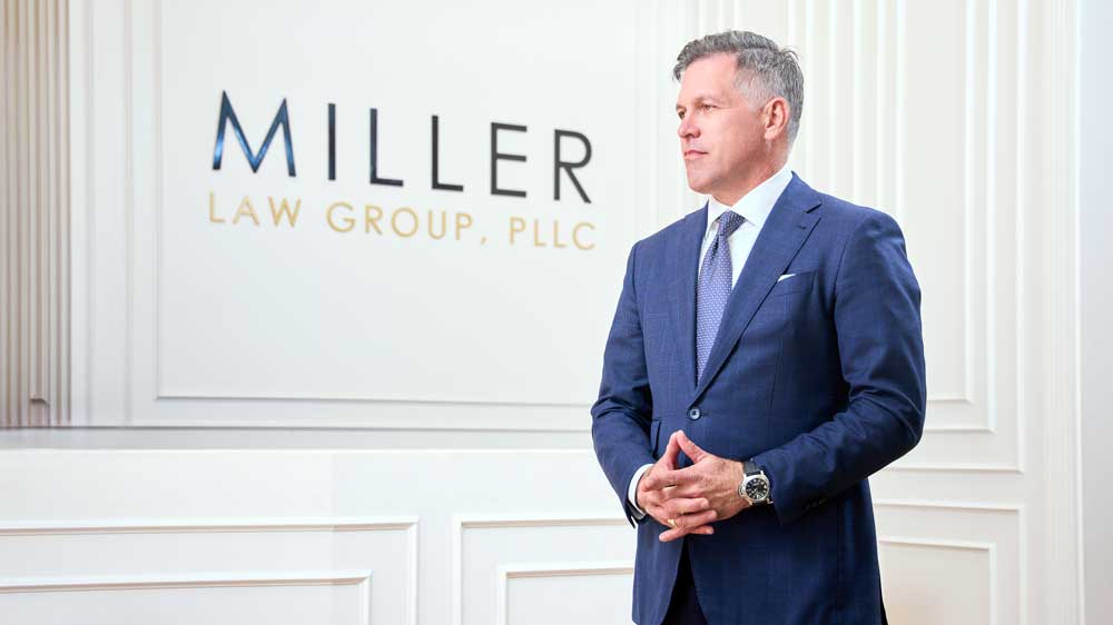Stacy Miller in front of Miller Law Group sign 2023