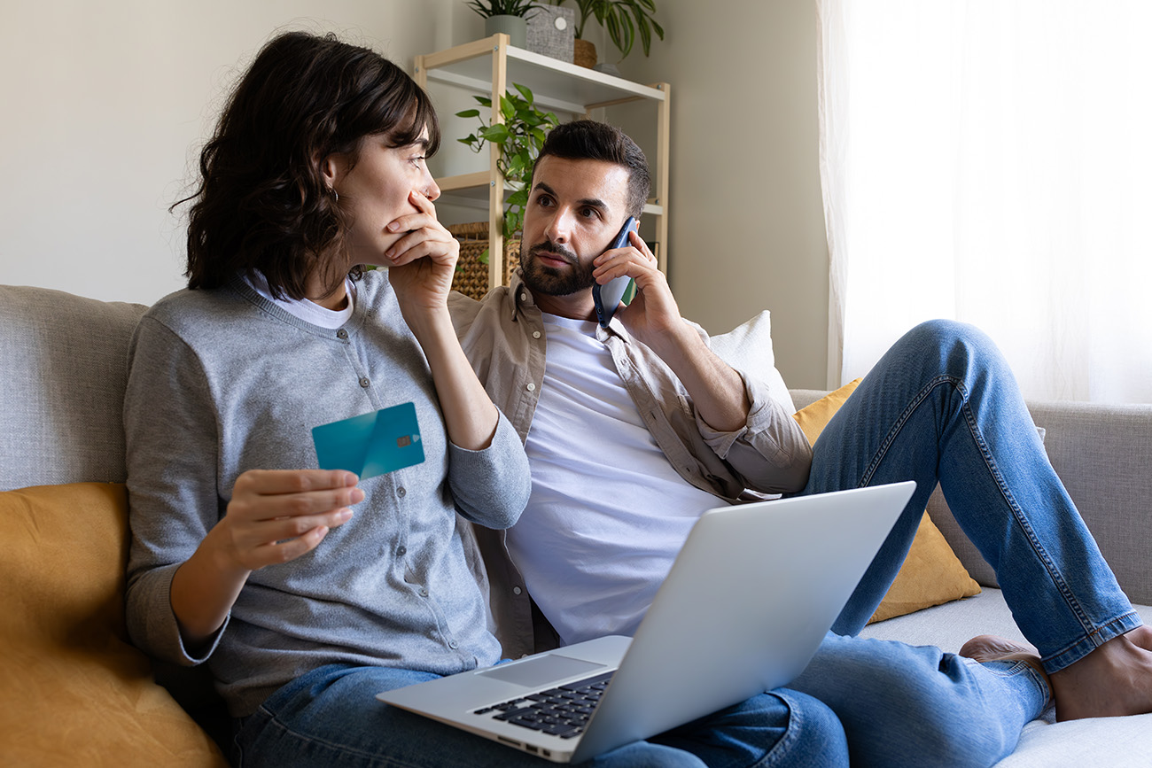 Young couple worried about credit card problems while making online purchases