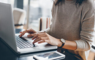 Woman typing on a computer