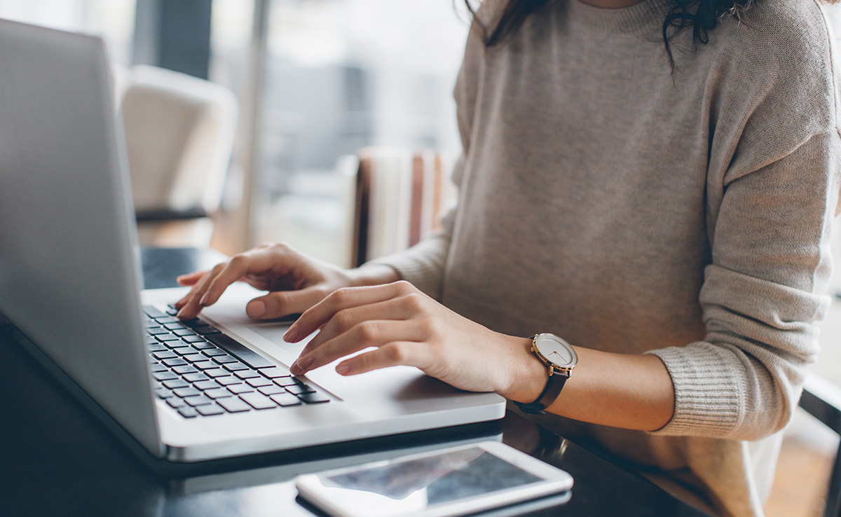 Woman typing on a computer